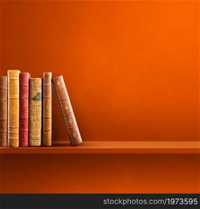 Row of old books on orange shelf. Square scene background. Row of old books on orange shelf. Square background