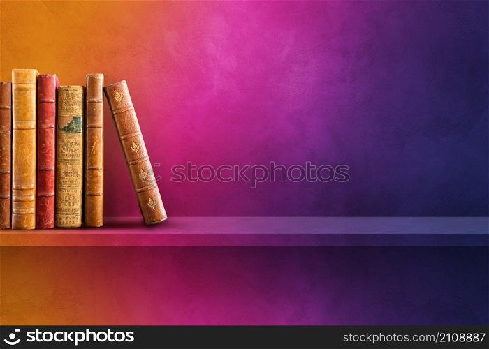 Row of old books on rainbow shelf. Horizontal background scene. Row of old books on rainbow shelf. Horizontal background