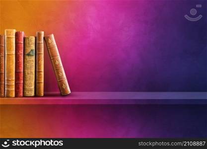 Row of old books on rainbow shelf. Horizontal background scene. Row of old books on rainbow shelf. Horizontal background