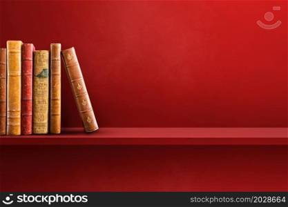 Row of old books on red shelf. Horizontal background scene. Row of old books on red shelf. Horizontal background