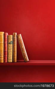 Row of old books on red shelf. Vertical background scene. Row of old books on red shelf. Vertical background