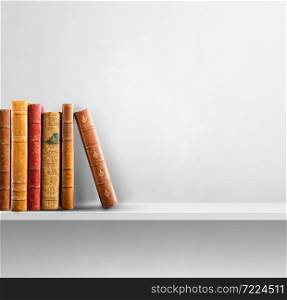 Row of old books on white shelf. Square scene background. Row of old books on white shelf. Square background