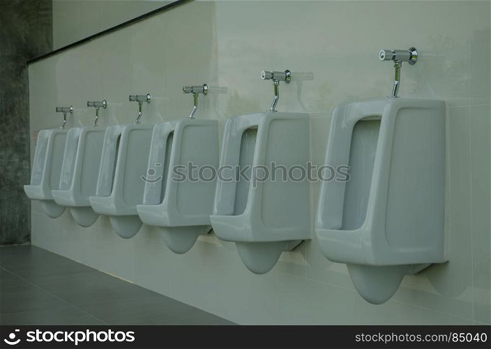 row of outdoor urinals men public toilet