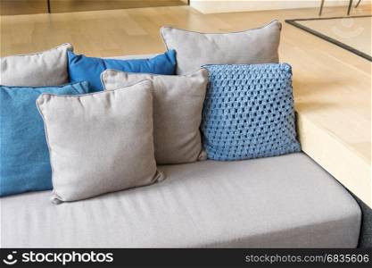row of pillows on sofa in living room