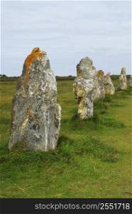 Row of prehistoric megalithic monuments menhirs in Brittany, France