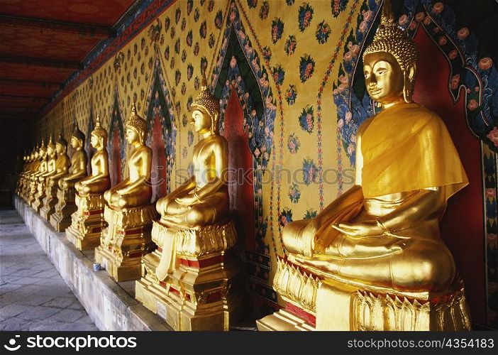 Row of statues of Buddha in a temple, Wat Arun, Bangkok, Thailand