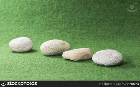 row of stones on green background