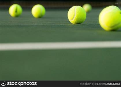 Row of Tennis Balls on Court Surface