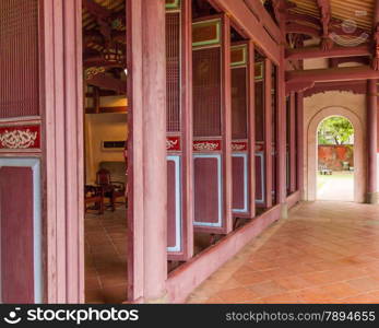 Row of traditional Chinese style doors with passage leading to exit