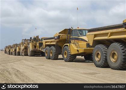 Row of trucks at landfill site