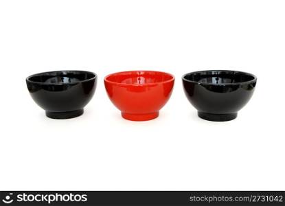 Row of two black and one red porcelain bowls isolated