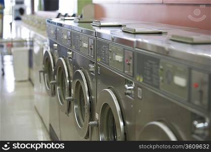 Row of washing machines in launderette