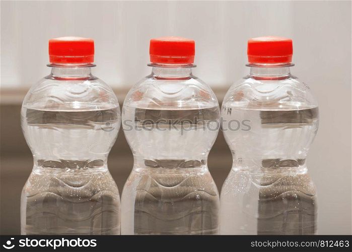 Row of water bottles, bubbling spa red, recycling environment concept close-up. Row of water bottles, bubbling spa red, recycling environment concept