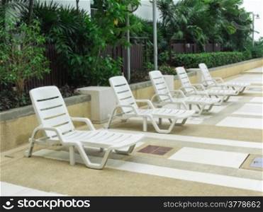 Row of white Beach chairs on daylight