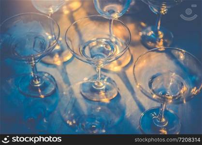 Row of wineglasses on table in nightclub bar and pub restaurant. Glassware and drinking beverage concept