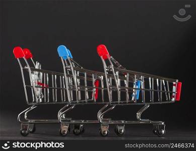 row shopping trolleys with red blue handles