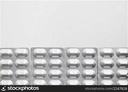 row silver blister pack pills isolated white background