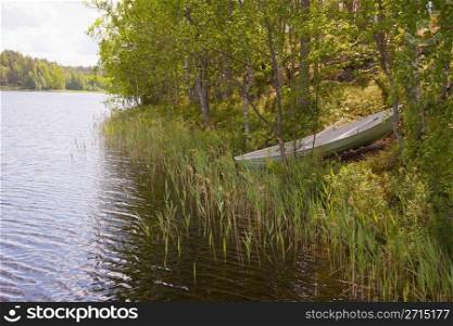 Rowboat stranded ashore at a lake in Finland