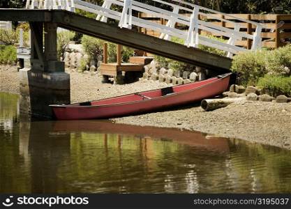 Rowboat under a bridge over a canal