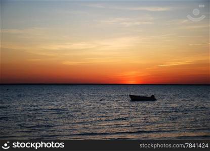 Rowing boat at sunset by the coast of Baltic Sea in Sweden.
