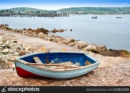 Rowing boat on slipway of old seaside town
