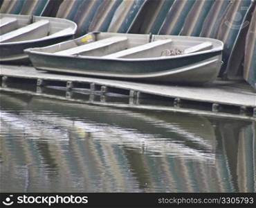 Rowing boats stacked on a pier waiting for the next season