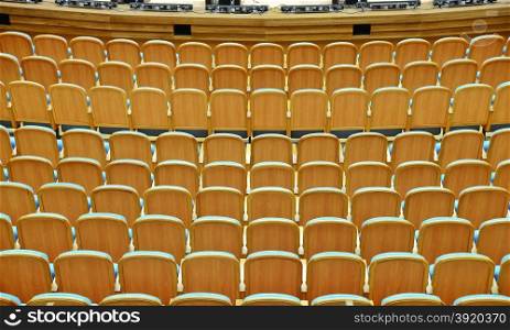 Rows of blue velvet armchairs in the auditorium