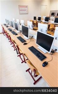 Rows of computers in classroom on high school