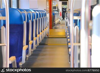 Rows of seats in a passenger train car.