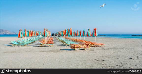 Rows of Sun loungers on a sandy beach waiting for tourists to arrive, shot on Elafonissos, Crete, Greece