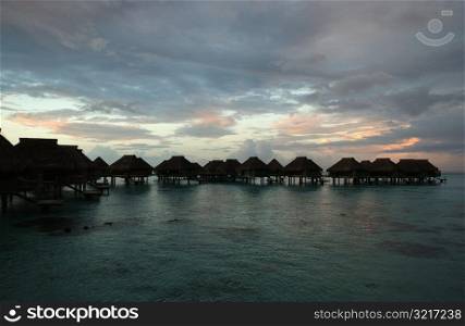 Rows of thatched buildings on stilts in the sea, Moorea, Tahiti, French Polynesia, South Pacific
