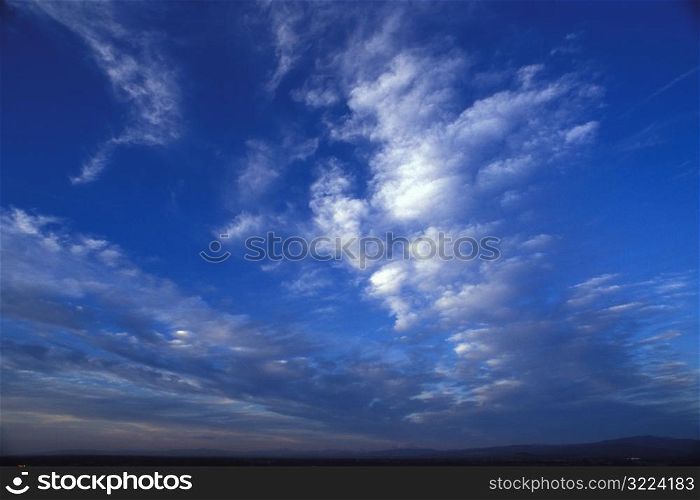 Rows Of Thin Clouds In A Dark Blue Sky