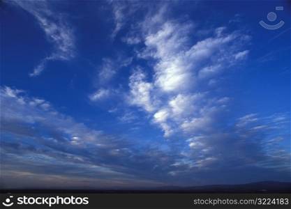 Rows Of Thin Clouds In A Dark Blue Sky