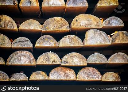 Rows of wooden logs in lumber mill for background