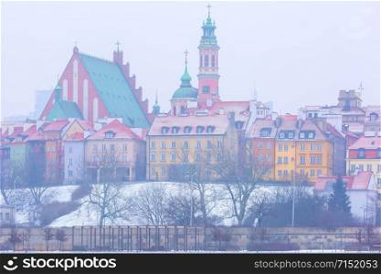 Royal Castle and colorful houses by the Vistula River in Warsaw, Poland.. Old Town and river Vistula at night in Warsaw, Poland.