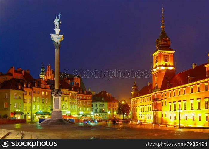 Royal Castle and Sigismund Column at Castle Square illuminated in Warsaw Old town at night, Poland.