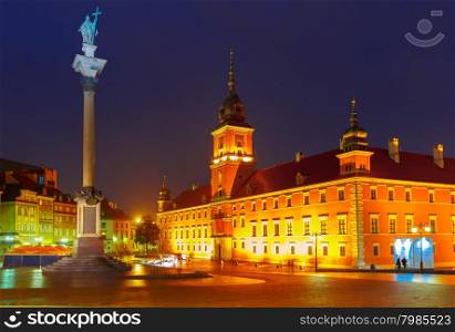 Royal Castle and Sigismund Column at Castle Square illuminated in Warsaw Old town at rainy night, Poland.