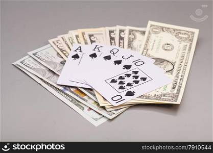 royal flush playing cards and dollars isolated on gray background