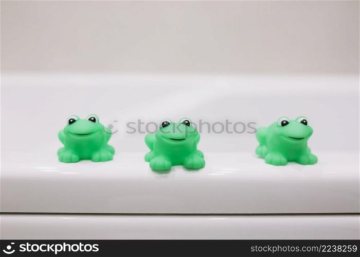 rubber frogs bathing