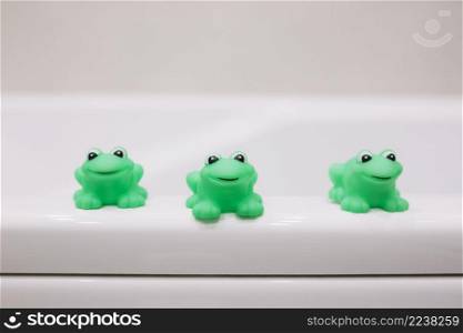 rubber frogs bathing