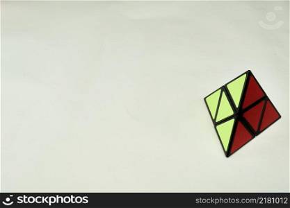 rubik&rsquo;s cube pyramorphix, solved on white background with copy space 2.. rubik&rsquo;s cube pyramorphix, solved on white background with copy space 2