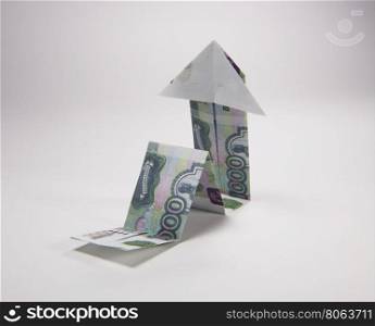 rubles arrow origami. Arrow origami made of rubles bills on a white background