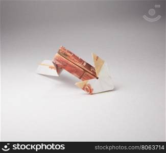 rubles arrow origami. Arrow origami made of rubles bills on a white background