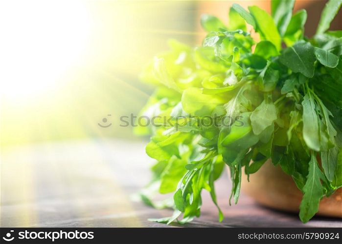 rucola. Fresh organic rucola leaves on a wooden table