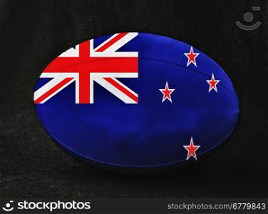 Rugby ball with New Zealand flag colors, over black background