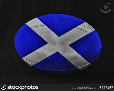 Rugby ball with Scotland flag colors, over black background