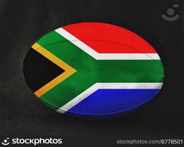 Rugby ball with South Africa flag colors, over black background