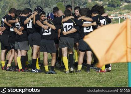 Rugby team standing in a circle