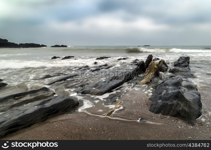 Rugged long exposure landscape seascape of rocky coastline