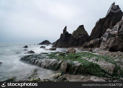 Rugged long exposure landscape seascape of rocky coastline